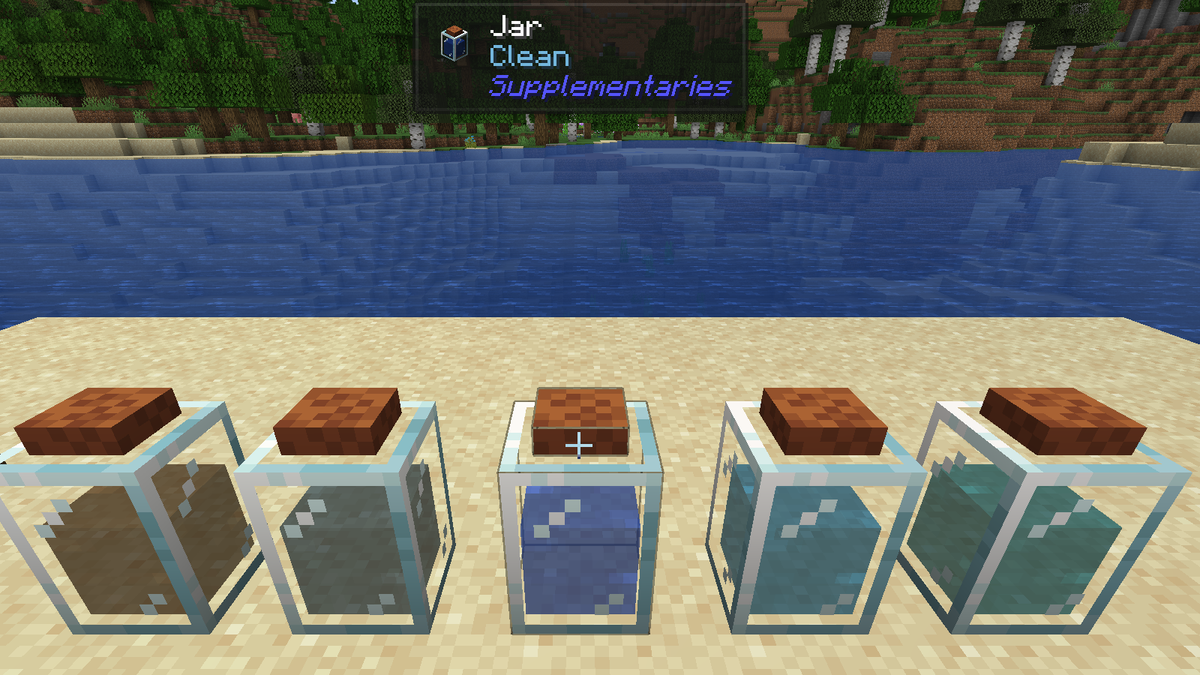 Five jars of water on a lakeshore, brown, grey, blue, cyan and turquoise, with Jade naming the middle one Clean
